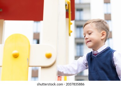 Cute Boy First Grader At School On The Playground On A Sunny Autumn Day. Celebration On September 1st. Knowledge Day. Selective Focus