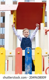 Cute Boy First Grader At School On The Playground On A Sunny Autumn Day. Celebration On September 1st. Knowledge Day. Selective Focus