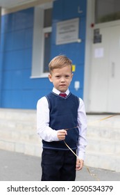 Cute Boy First Grader At School With A Balloon In His Hand On A Sunny Autumn Day. Celebration On September 1st. Knowledge Day. Selective Focus