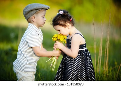cute boy and girl on summer field - Powered by Shutterstock