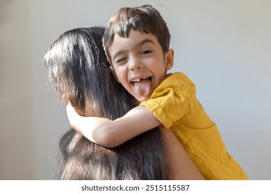 Cute boy is hugging his mother. Siblings day. Family concept. Little child. - Powered by Shutterstock