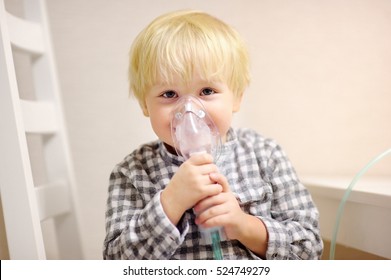 Cute Boy Inhalation Therapy By The Mask Of Inhaler. Close Up Image Of A Little Kid With Respiratory Problem Or Asthma. Sick Boy With Clear Oxygen Mask.