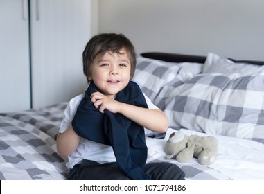 Cute Boy Learning How To Put Cloth On, 4 Year Old Kid Sitting In Bed With Teddy Bear  Wearing School Jumper,boy Getting Dressed And Get Ready For School, Child Dressing Uniform In Bed Room.