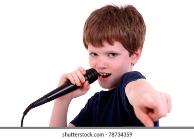 Cute boy with a microphone sings isolated on white, studio shot