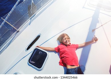 Cute Boy On Board Of Sailing Yacht On Summer Cruise. Travel Adventure, Yachting With Child On Family Vacation. Kid Clothing In Sailor Style, Nautical Fashion.