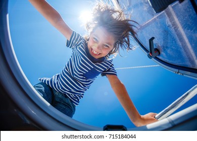 Cute Boy On Board Of Sailing Yacht On Summer Cruise. Travel Adventure, Yachting With Child On Family Vacation. Kid Clothing In Sailor Style, Nautical Fashion.