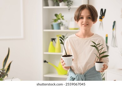 Cute boy with plants in workshop