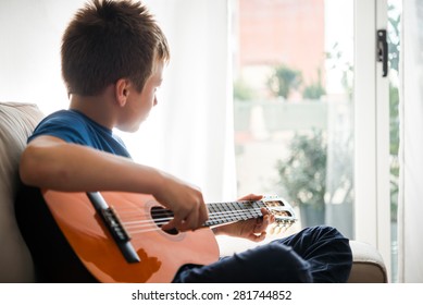 Cute Boy Playing Guitar