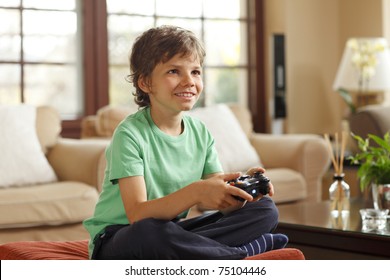 Cute Boy Playing Video Games At Home