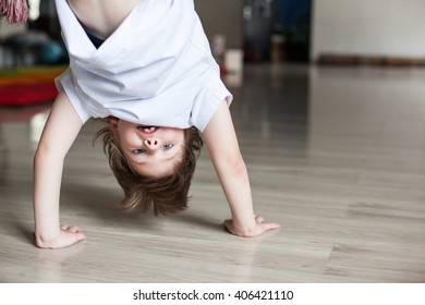 cute boy practicing capoeira (brazilian martial art that combines elements of dance, acrobatics and music), handstand 