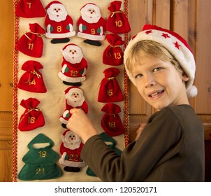 Cute Boy With Santa's Hat Opening Advent Calender