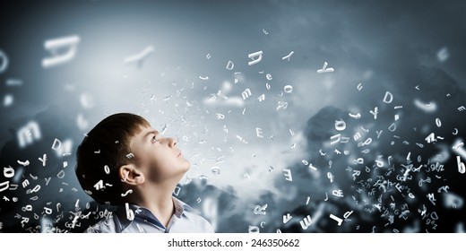 Cute boy of school age and letters flying around