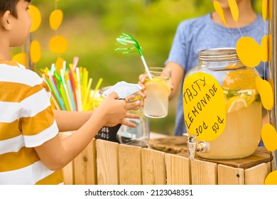 Cute Boy Selling Lemonade In Park