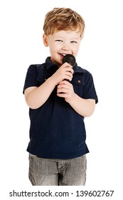 Cute boy singing with microphone shot as cutout on studio white background.