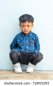Cute boy sitting and looking to camera