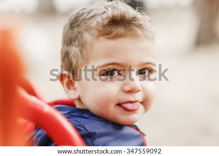 Image, Stock Photo Little cute boy looking at camera and sticking out his tongue