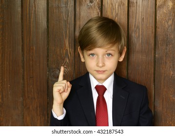 cute boy in suit and tie on a wooden background