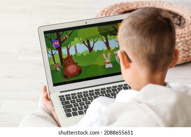 Cute boy watching cartoons at home - Shutterstock ID 2088655651