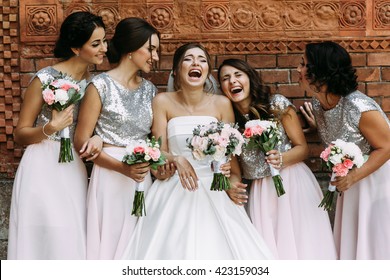 Cute bridesmaids and a bride are laughing - Powered by Shutterstock