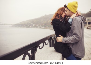 Cute brunette loving couple on a date. cold autumn, winter or spring day, european city. copy space