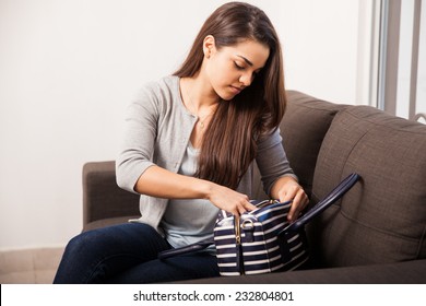 Cute Brunette Sorting Things Inside Her Purse Before Heading Off For Work