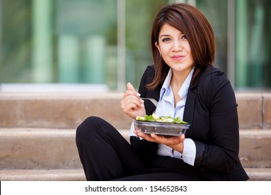 Cute Business Woman Eating A Healthy Salad And Relaxing Outdoors