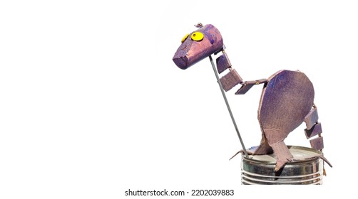 Cute Cardboard Dinosaur Made By A Child. Isolated Purple Dinosaur With Yellow Eyes And Funny Facial Expression. DIY Papercraft Project Ideas Or Kids Crafts And Creative Activities. Selective Focus.