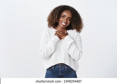Cute carefree smiling african-american curly-haired woman press palms heart thankfully appreciate nice gesture tilt head smiling delighted thanking, gratefully looking, value effort