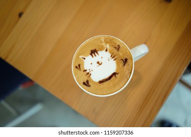 Cute Cat Latte Art In A White Cup On Wooden Table