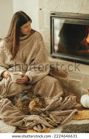 Similar – Mother hugging her baby in front of fireplace