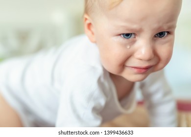 Cute Caucasian Blond Toddler Boy Portrait Crying At Home During Hysterics. Little Child Feeling Sad. Little Actor Acting Sadness Emotions Demanding Something