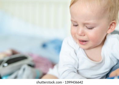 Cute Caucasian Blond Toddler Boy Portrait Crying At Home During Hysterics. Little Child Feeling Sad. Little Actor Acting Sadness Emotions Demanding Something