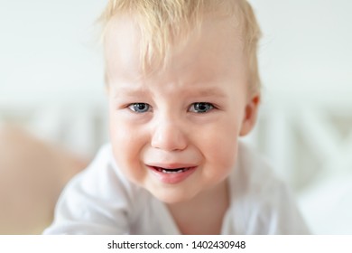 Cute Caucasian Blond Toddler Boy Portrait Crying At Home During Hysterics. Little Child Feeling Sad. Little Actor Acting Sadness Emotions Demanding Something