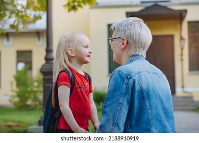 Cute Caucasian Blonde Little Girl Going To School. Mother Having A Conversation With Child, Saying Goodbye And Givng Advice. Back To School Concept