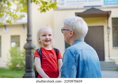 Cute Caucasian Blonde Little Girl Going To School. Mother Having A Conversation With Child, Saying Goodbye And Givng Advice. Back To School Concept