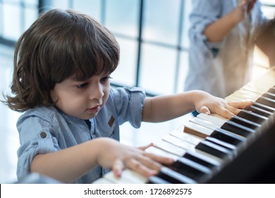 Cute Caucasian Boy Enjoy Playing Old Piano, Duet With His Brother