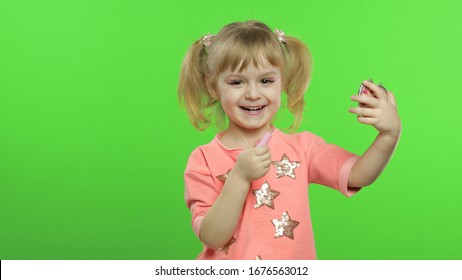 Cute caucasian girl on chroma key background applying red lipstick. Pretty child taking care of herself. Cosmetics and makeup. Face care, decorative cosmetics, childhood. - Powered by Shutterstock