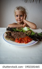 Cute Caucasian Little Girl Eating Helpthy Vegetarian Food. Red Quinoa And Falafel With Tomato Sauce.