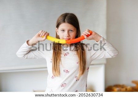 Cute Caucasian Long Hair Preteen Kid Girl Playing With Two Pop Tubes Fashion Fidget Finger Toys Mini Tubes Stretch Pull Tube Light Real Interior