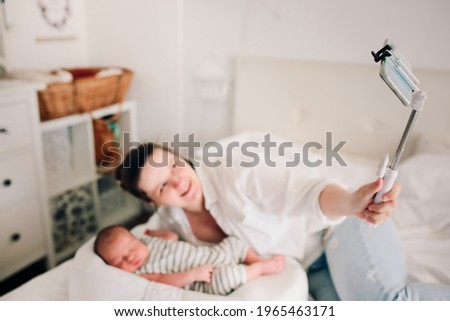 Similar – Relaxed mother and sons playing over the bed