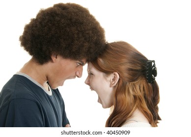 A cute Caucasian teenage girl and her mixed-race teen boyfriend yell at each other