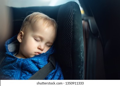 Cute Caucasian Toddler Boy Sleeping In Child Safety Seat In Car During Road Trip. Adorable Baby Dreaming Asleep In Comfortable Chair During Journey In Vehicle. Children Care And Safety On Roads