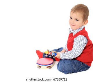 Cute Caucasian Toddler Playing With Music Instruments. All Isolated On White Background. Extra Copy Space On Left Side.