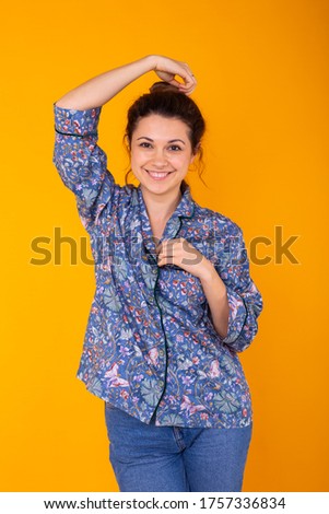 Cute and cheerful woman studio lifestyle yellow background emotions.