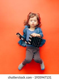 Cute Child Actor Holding Cinema Clapper. Funny Talented Toddler Girl Pursuing An Early Acting Career
