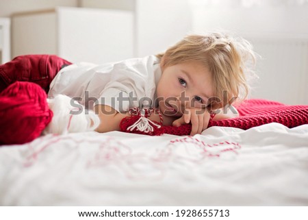 Little girl smiling lying over the bed