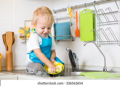 Cute Child Boy 2 Years Old Washing Up In Kitchen