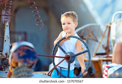 Cute Child Boy Pretends Driving An Imaginary Car