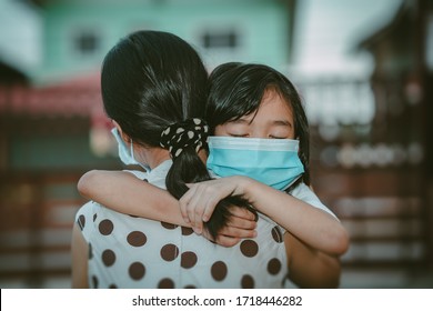 Cute child daughter hugging mother on blurred home background, kids school back to home on mather's day, Asian children and mother wearing mask protect coronavirus 19 and pm 2.5 particle in air, Thai - Powered by Shutterstock