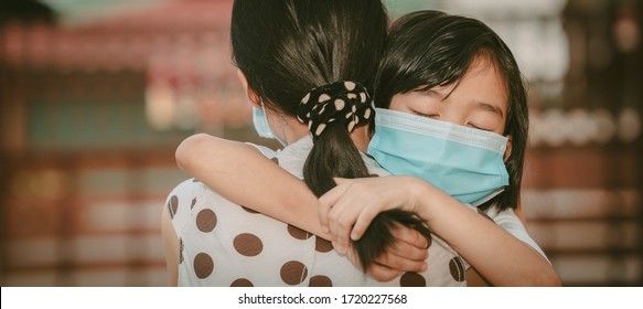 Cute child daughter hugging mother on blurred home background, kids school back to home on mather's day, Asian children and mother wearing mask protect coronavirus 19 and pm 2.5 particle in air - Powered by Shutterstock